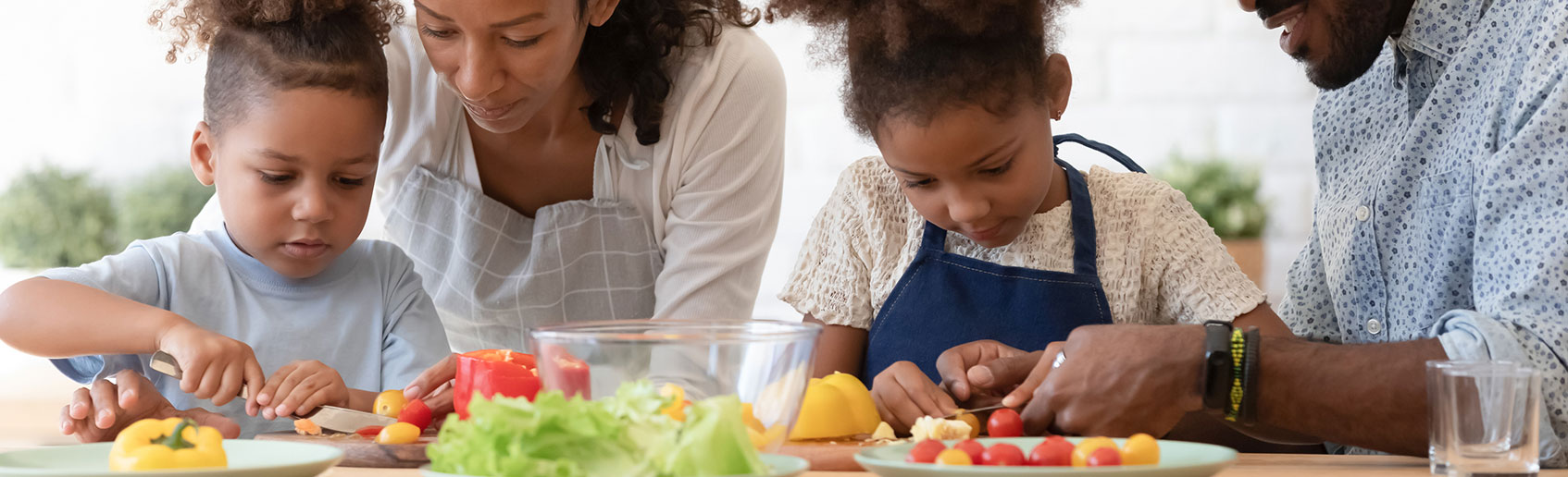 Family cooking healthy food together in the kitchen